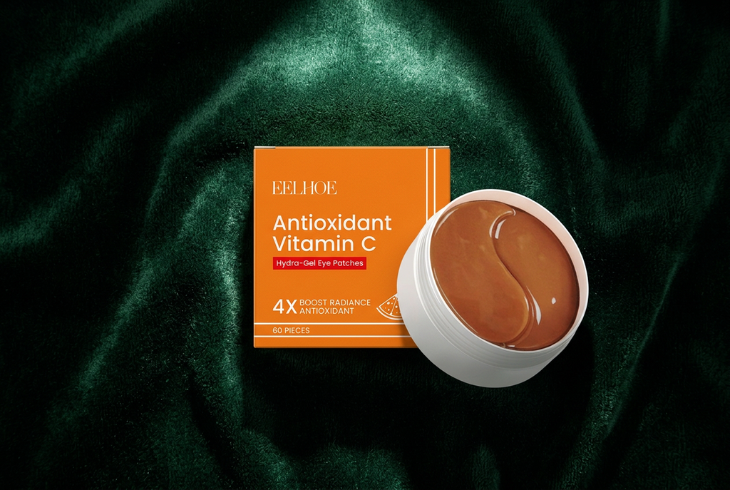 EELHOE Vitamin C Eye Patches on dark velvet with dramatic spotlight