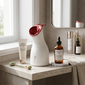 White beauty humidifier next to skincare bottles on vanity showing proportions